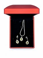 Image of necklace and matching earrings displayed in a red box with black interior.