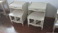 Pair of solid wood side tables with drawers and cabinet doors, showing overall design and condition.