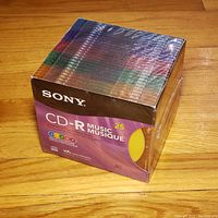 Sealed pack of 25 Sony CD-R music discs with multi-color spines visible.