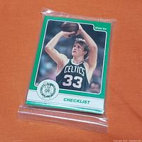Stack of Larry Bird basketball cards with green border sealed in clear factory shrink wrap, front view shows Bird in Celtics #33 uniform shooting a basketball with 'Checklist' text.