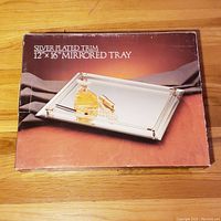Original box showing the product name and image of the mirrored tray with silver plated trim, size 12 x 16 inches.
