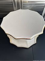 Top view of the white porcelain stand showing scalloped edges and gold trim.
