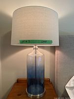 Single glass lamp showing full profile and shade