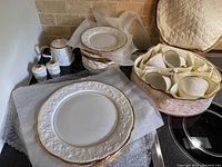 Overview of multiple plates, bowls, teacups, saucers and salt & pepper shakers on bubble wrap showing the full set.