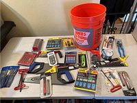 Overview of the table showing all tools including Channel Lock pliers, hacksaw, staple assortment, clamps, file set, drill bits, and more