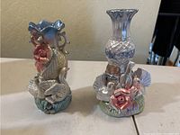 Photo of two porcelain vases with colorful floral and bird designs