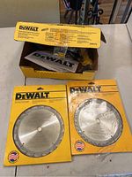 DeWalt drywall screwdriver in original box with manual, two DeWalt packaged circular saw blades