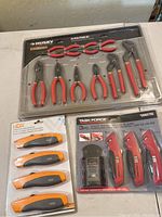 Photo showing Husky 10-piece pliers set, Task Force 3-piece utility knives with 50 replacement blades, and HDX 4-piece knives in original packaging.