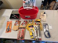 Full overview of all items in the lot spread on a table showing tools, scissors, gloves, and tool caddy.