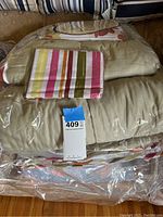 King comforter and sheet set, folded and sealed in plastic packaging.