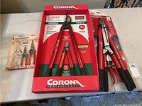 Photo showing Corona Professional pruning tools in packaging, including large lopper and pruning shear.