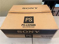 Sony PS-LX250H stereo turntable system in its original brown cardboard box, unopened or partially opened, showing branding and model number.