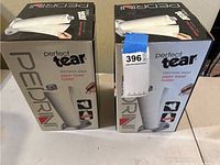Two boxed Pedrini Perfect Tear stainless steel paper towel holders side by side showing brand and packaging.