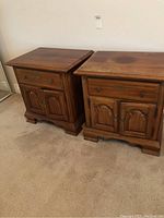 Pair of solid wood nightstands side by side showing overall design and condition
