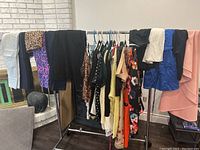 Image showing a rack of assorted ladies clothes mostly dresses and tops in a mix of colors and patterns.