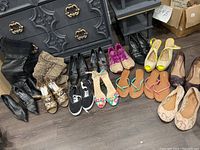 Full front view of the assortment of ladies shoes, showing a variety of styles including boots, heels, flats and sandals