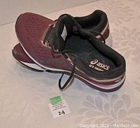 Pair of Asics GT-1000 women's running shoes size 7, top view showing design and laces.
