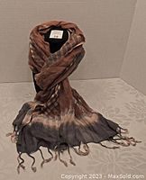 Scarf wrapped around mannequin showing fabric pattern and tassels