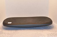 Top view of the black balance board showing textured foam surface for cushion while standing.