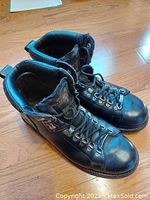 Pair of men's black leather Harley Davidson motorcycle boots, size 10, viewed from above showing lace-up front and padded collar.