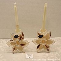 Pair of Murano blown glass flower candle holders with candles inserted, showing front view with label intact