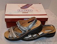 Side angle view of Tender Tootsies Clinic comfort sandals with original box visible.