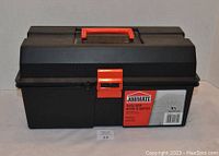 Closed view of the black plastic Job Mate tool box with red handle and red latch front, showing the branding label and overall condition.