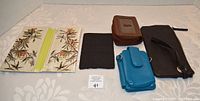 Top view of six wallets and pocketbooks showing colors and designs
