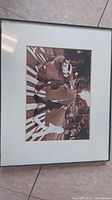 Front view of sepia toned Beatles Abbey Road photo in simple black frame with white matting.