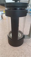 Front view of the Bodum Starbucks French Press showing the handle with Starbucks branding and internal metal plunger mechanism.