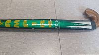 Close-up of the mid-section of the hockey stick showing the green shaft with BRIO Classic branding and design details.