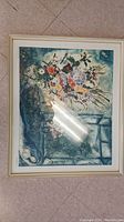 Full view of the framed floral art print on floor showing the entire artwork and frame.
