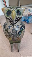 Front view of Mexican hand-painted ceramic owl showing detailed facial features and floral designs.