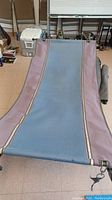 Full view of the purple and blue fabric hammock sling showing color and material details.