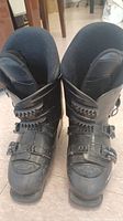 Pair of Rossignol black ski boots with visible scuffs, buckles, and interior lining