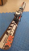 Close-up photo of one of the XR Junior skis showing XR Junior branding and one ski binding.