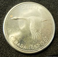 Reverse side of the coin showing flying Canada goose, denomination 'DOLLAR', and 'CANADA 1867-1967'