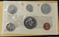 Front side of the sealed coin set with visible denominations and designs including the loon, beaver, and maple leaf coins.