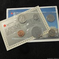 Front photo showing six coins from 1987 Canada Mint sealed inside clear packaging with printed informational sheet and backing card with Royal Canadian Mint logo and graphics.