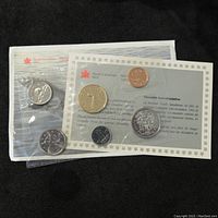 Front view of two sealed Royal Canadian Mint plastic pouches containing the 1992 uncirculated coin set, showing all six coins and informational inserts in English and French.