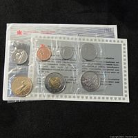 Front view of sealed packaging showing all seven Canadian coins from 1998, in uncirculated condition, with visible Royal Canadian Mint and bilingual text on insert.