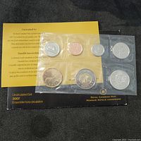Top side of 7 coin 2007 Canadian uncirculated set showing coins and informational insert along with black Royal Canadian Mint holder.