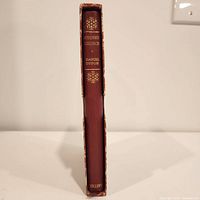 Spine of the leather bound book showing title 'Robinson Crusoe' by Daniel Defoe with gold embossed decoration and publisher name 'Putnam' at bottom.