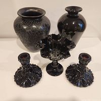 Front view showing all five items: two vases, one compote dish, two candle holders
