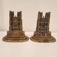 Front view showing the detailed cathedral structures on the two brass bookends.