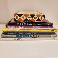 Stacked view of the eight books on fabric crafts showing titles and condition