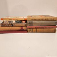 Stack of nine vintage books showing titles and general condition