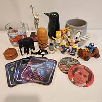 Full view of all collectibles including figurines, coasters, pins, mugs, and trophy