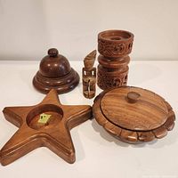 Overview of all wooden items including candle holders, carved figure, box with lid, and pedestal with dome