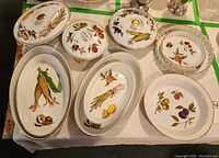 Overall view of eight porcelain dishes arranged on table